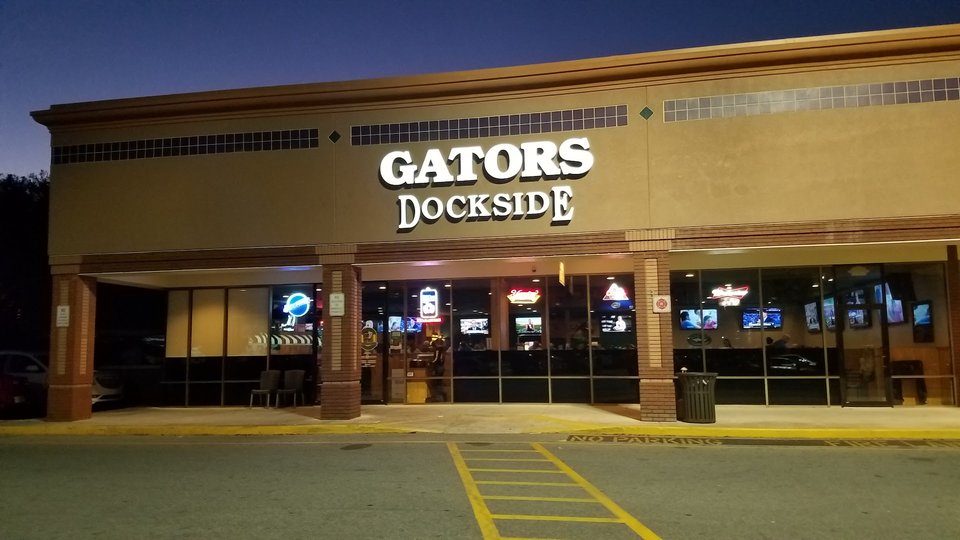 Sports bar with TVs and table seating.